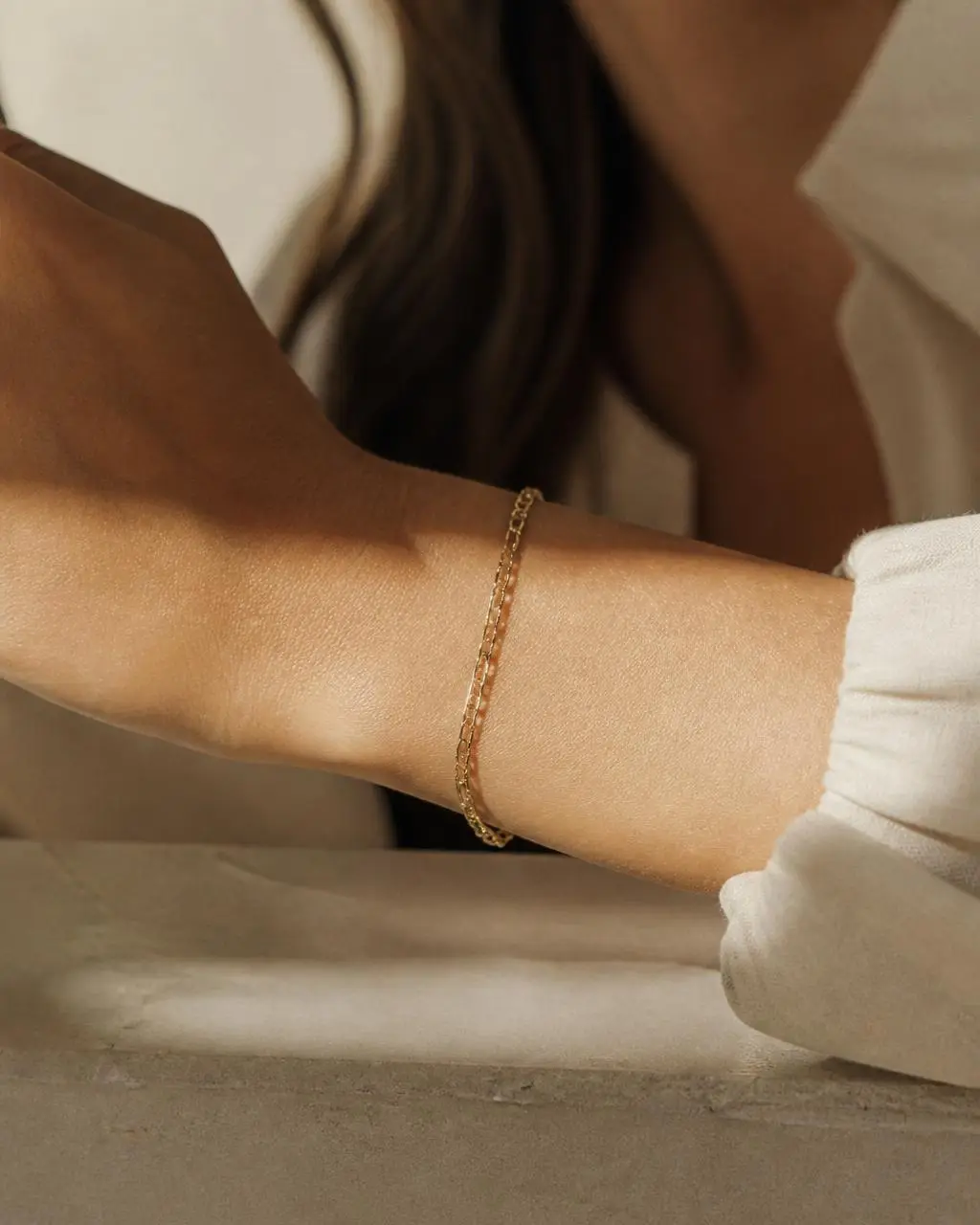 Slim handmade gold chain bracelet worn on the wrist